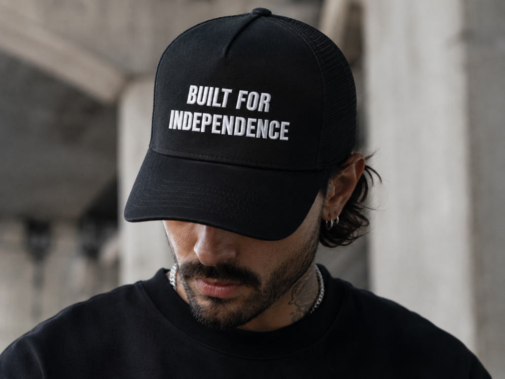 Embroidered Rise & Defy statement cap worn with casual streetwear
